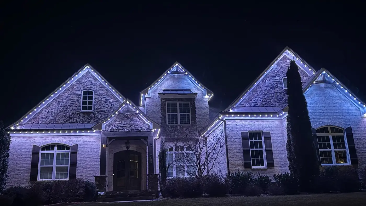 Stone mansion with cool blue roofline lights