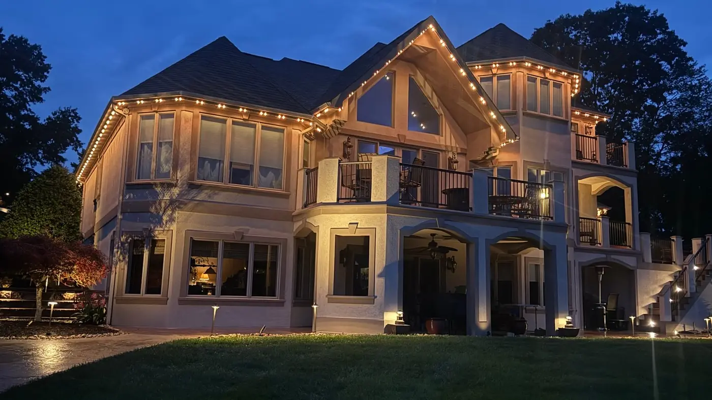 Luxury home with warm white accent lights at dusk