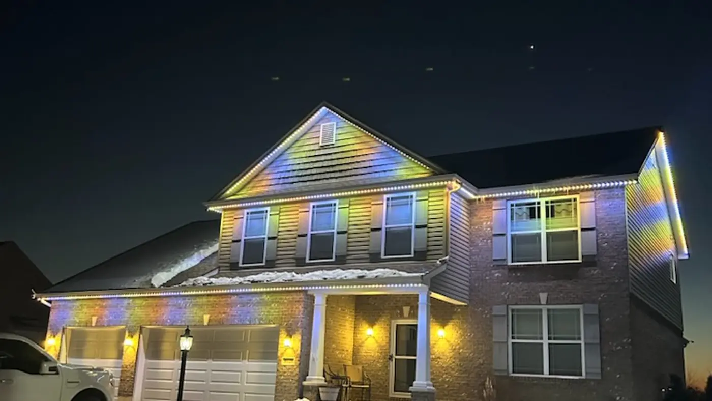 Permanent Holiday Lights 4 House with rainbow roofline holiday lights in snow